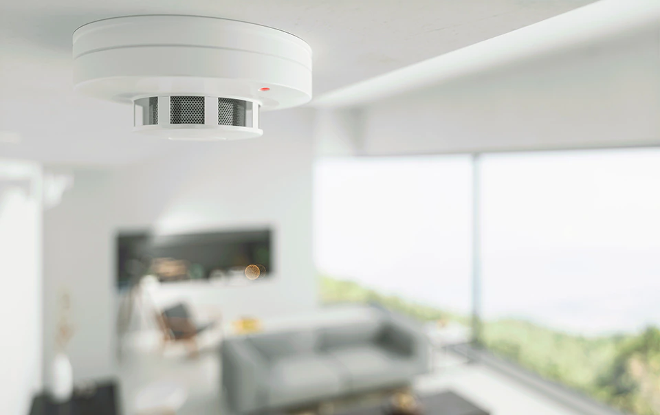 Image of fire detector on ceiling of a home.