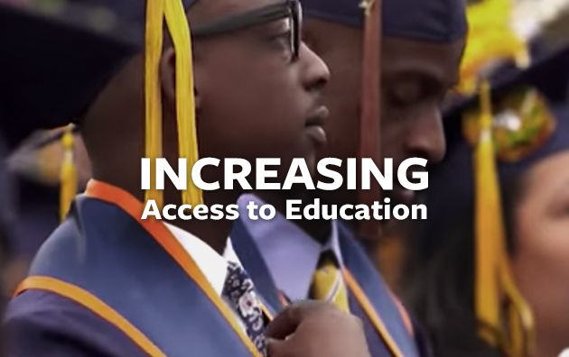 Young man wearing cap and gown standing at graduation ceremony.