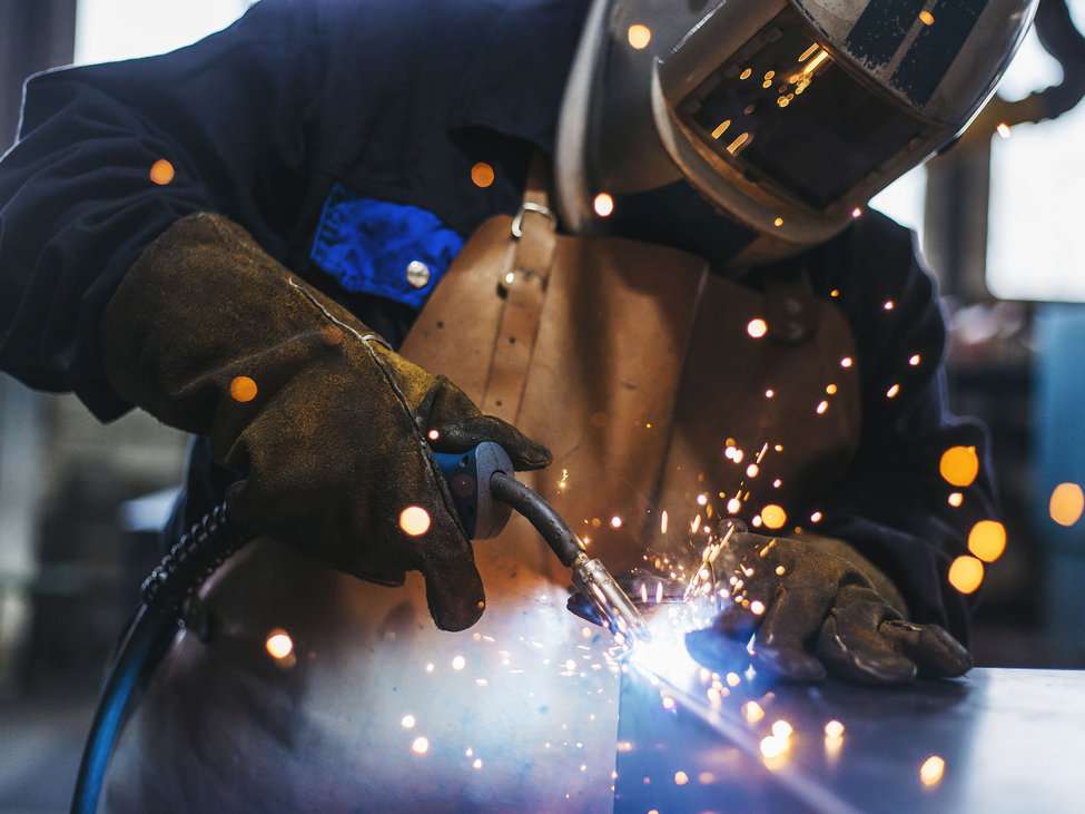 Industrial welder with torch.