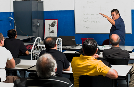 Instructor in front of class teaching truck driver students