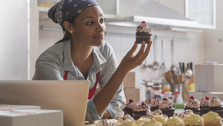 Lady holding a muffin.