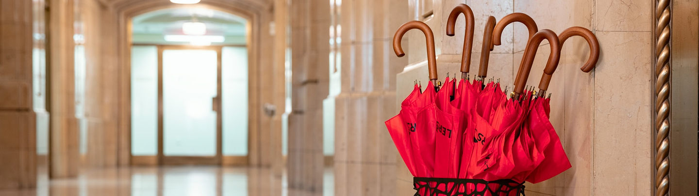 Hallway with red umbrellas in a stand