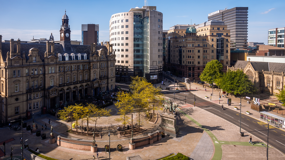 A wide-angle view of buildings and a plaza around the City Square in Leeds.