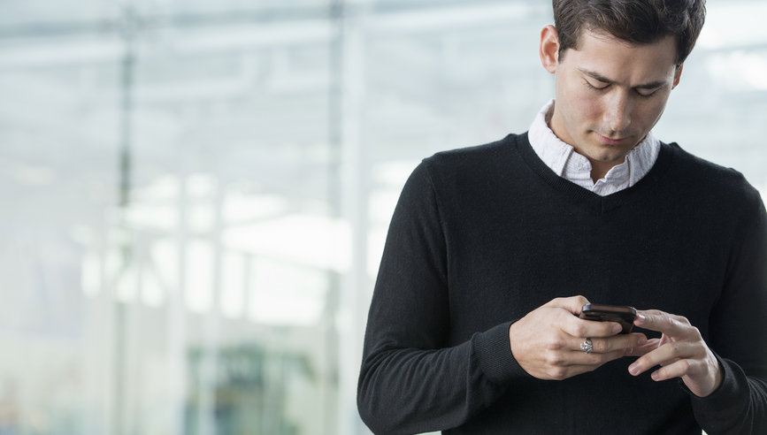 A young man checking his smart phone.