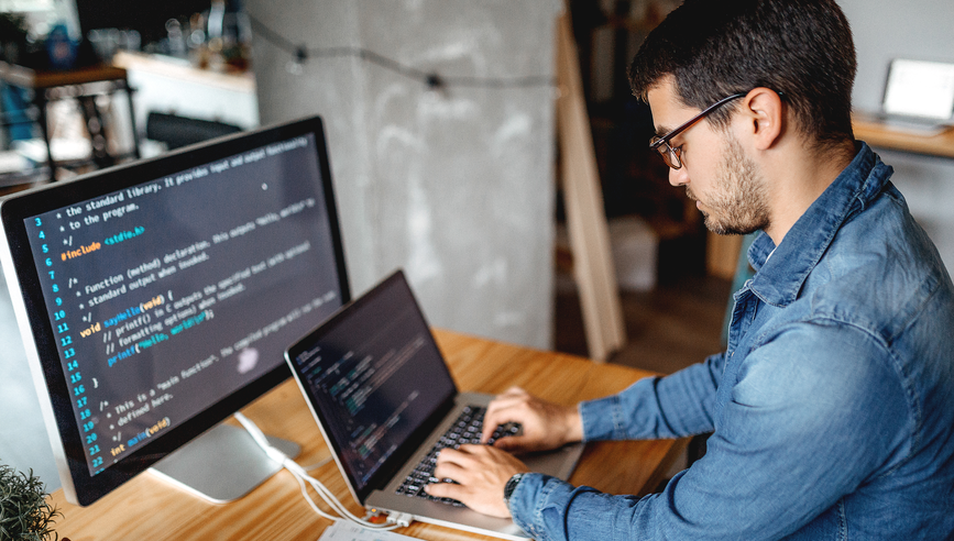 Male programmer working at home in his home office; Business can not wait