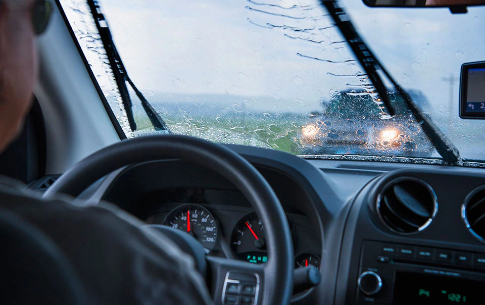 Man driving in a spring storm.