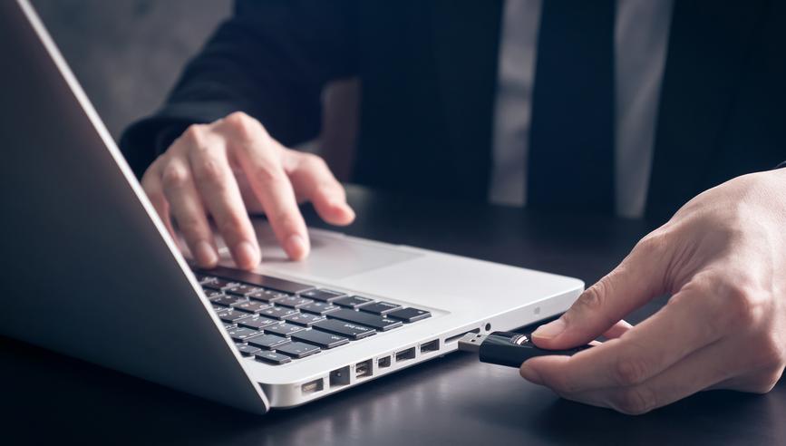 Businessman using flash drive connect to laptop