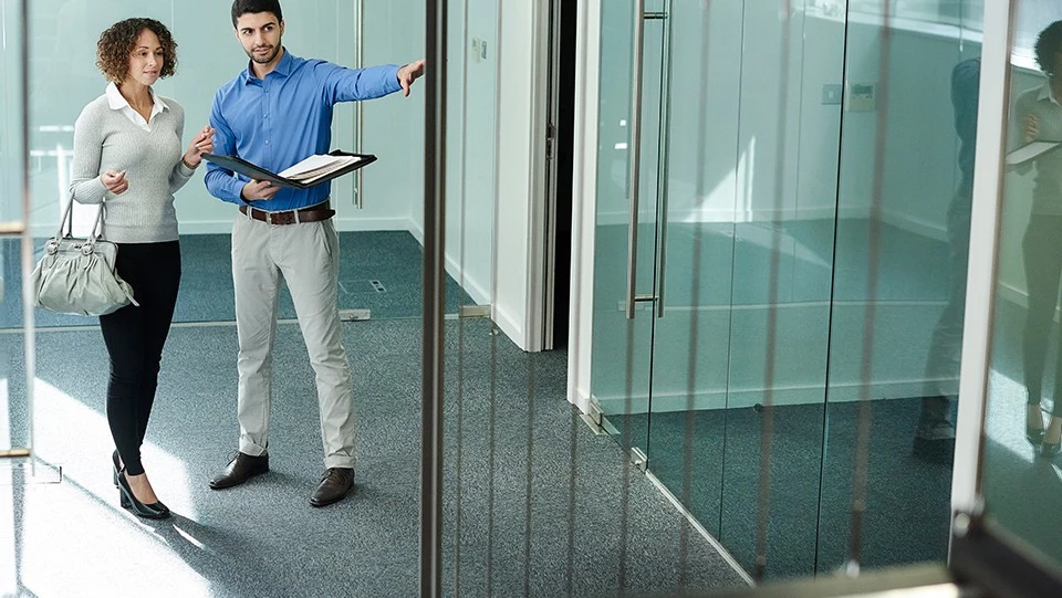 Man showing a woman vacant space.