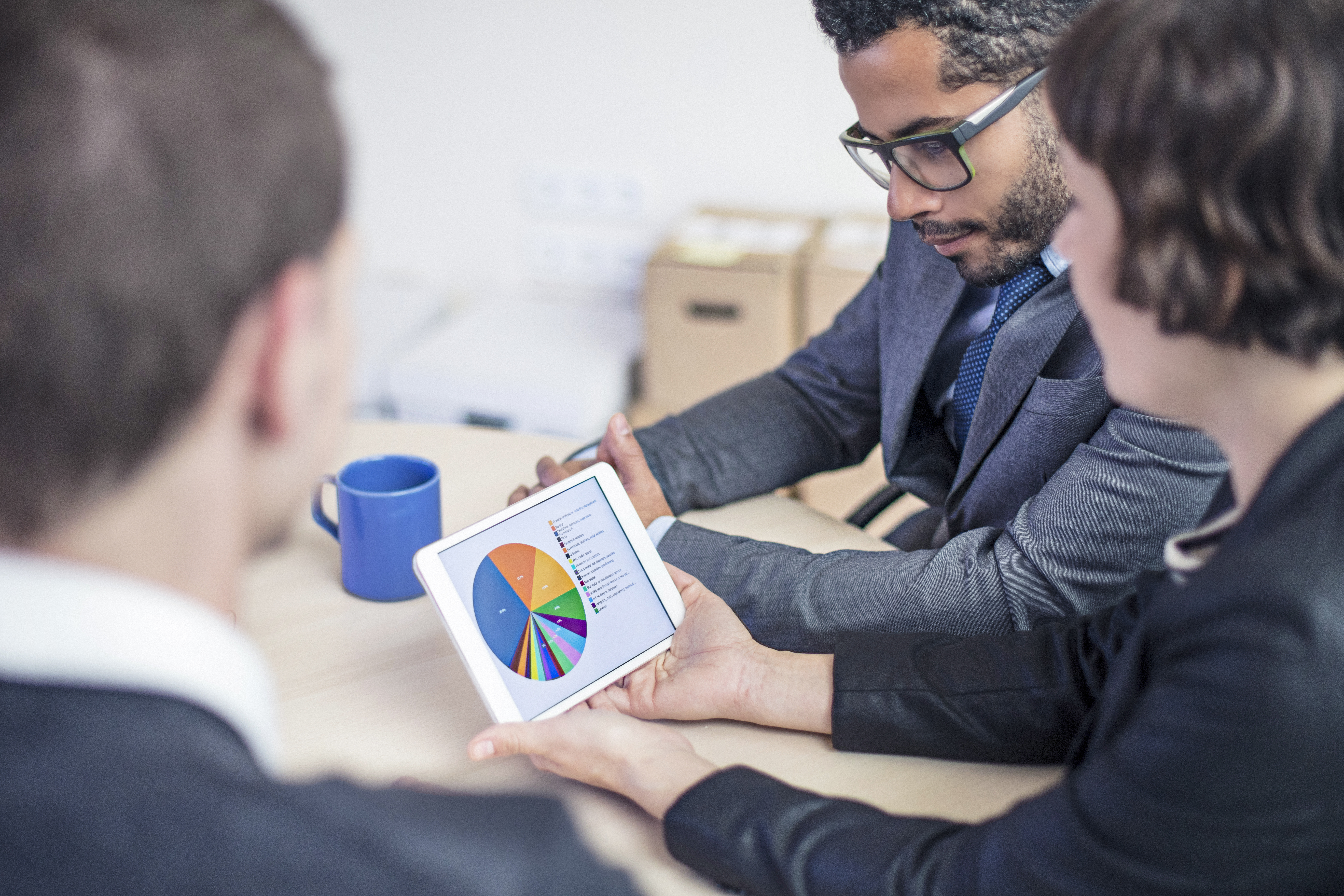 man shows graph to coworkers