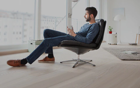 Man sitting in chair at home.