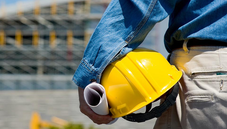 Man with hard hat working to create a safety culture in a new building.