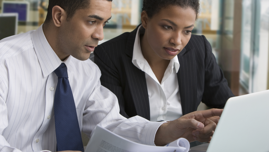 Businessman and businesswoman reviewing paperwork