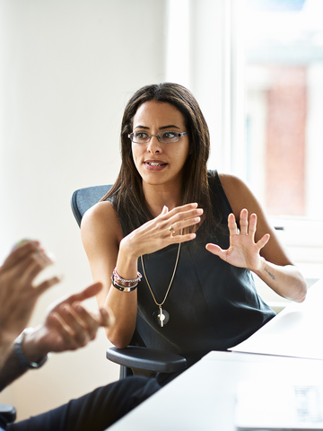 Tech sector professionals converse in an office setting.