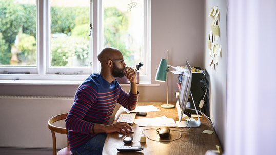 Man sitting at desk working from home.