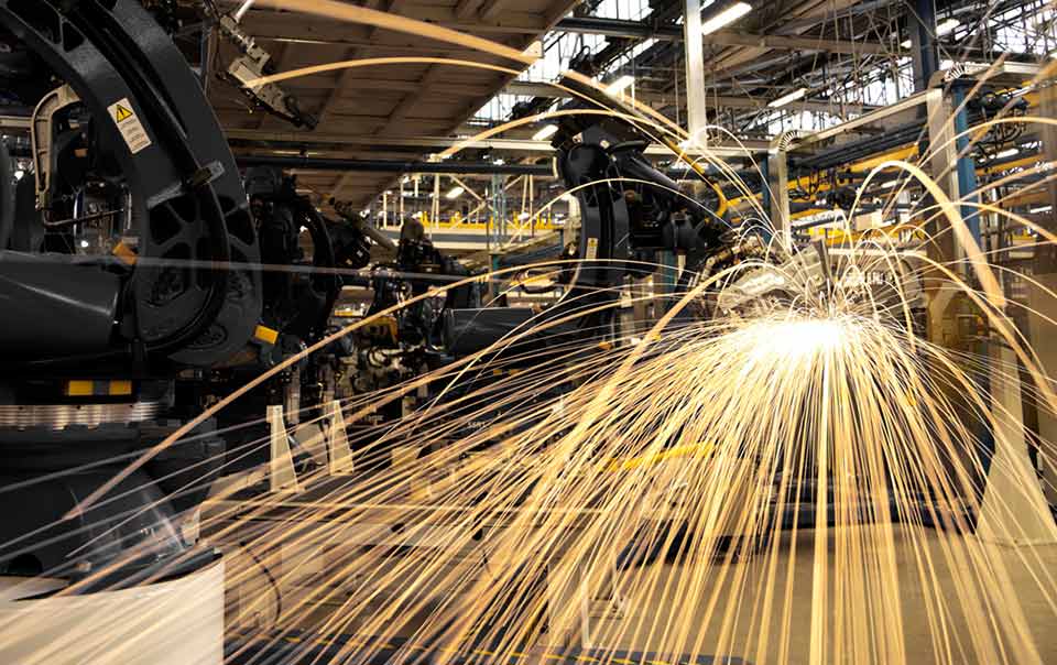 Sparks fly off machinery during manufacturing.