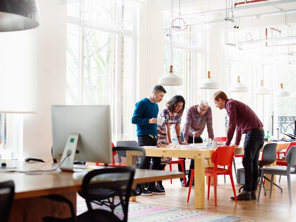 Colleagues gathered around a table in an office.