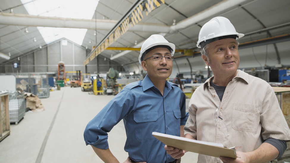 Workers meeting in manufacturing plant