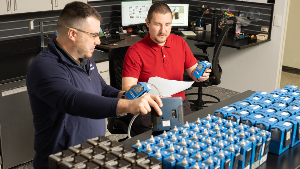 Two men work together at air sampling.