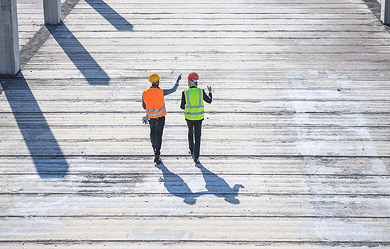 Workers walking on the construction field.