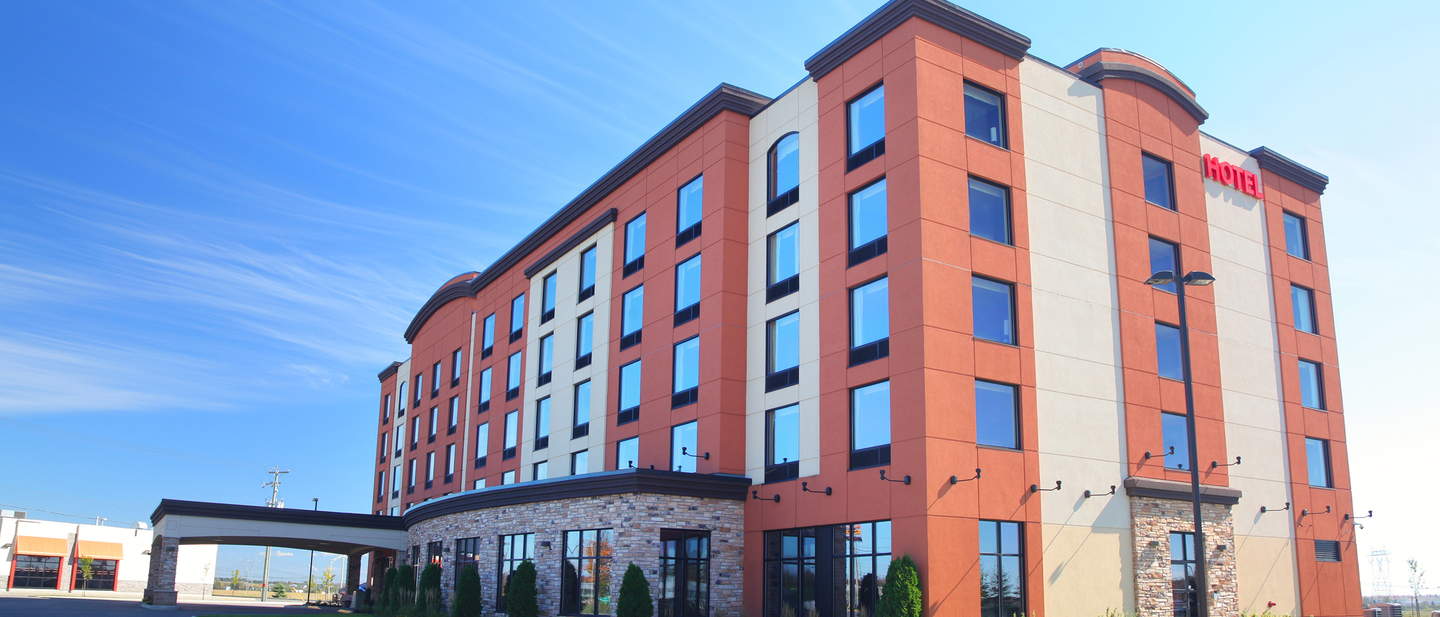 Exterior of a hotel against a blue sky.