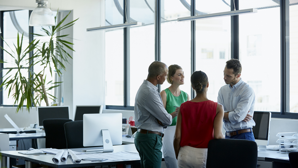 Confident professionals discussing in office