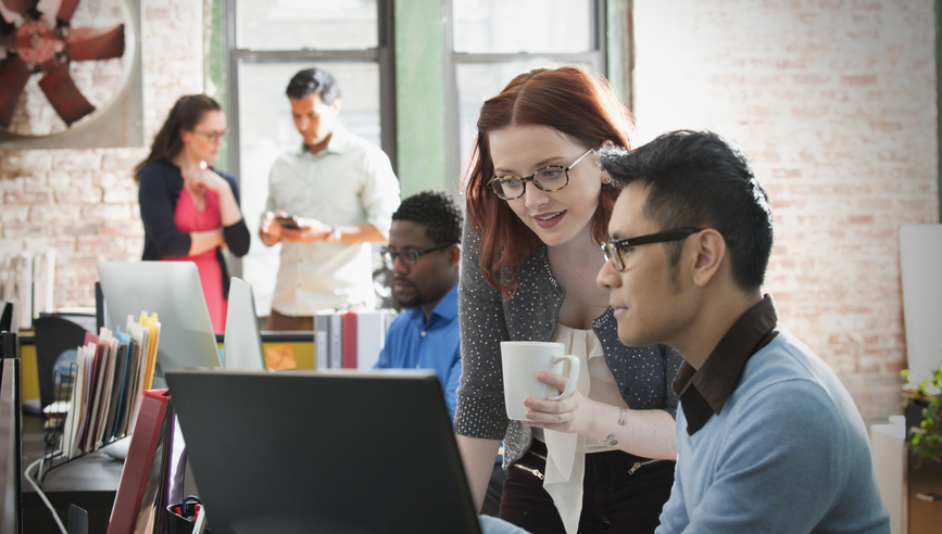 Business people using computer in office