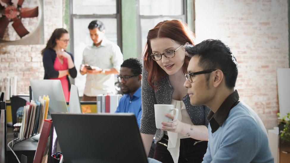 Business people using computer in office