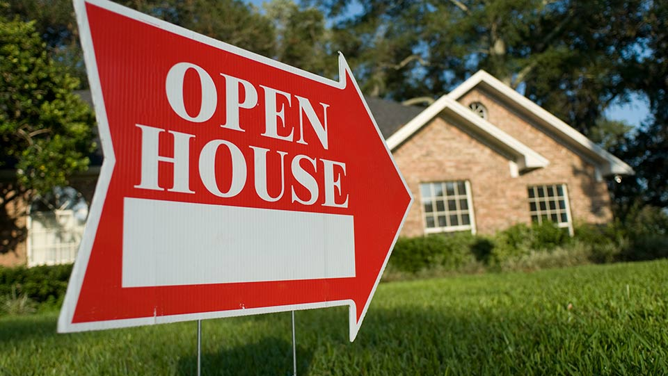 Open house sign on lawn.