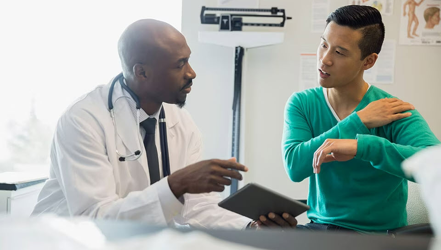 Doctor examining patient with chronic pain.