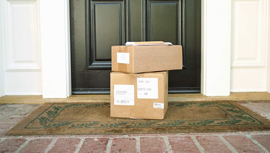 Packages on the front step of a house.