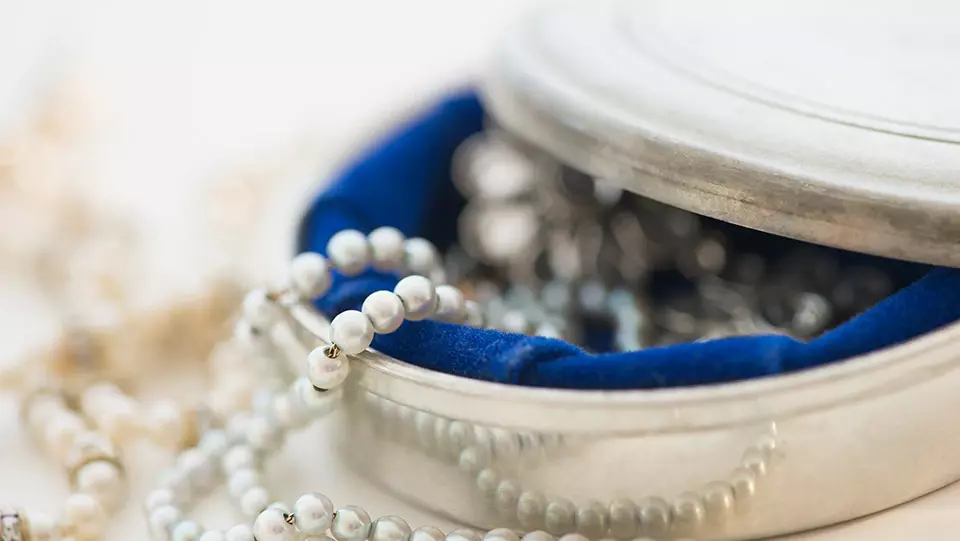 Pearls in a jewelry box covered in valuable items insurance coverage.