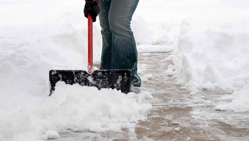 Person shoveling their sidewalk.