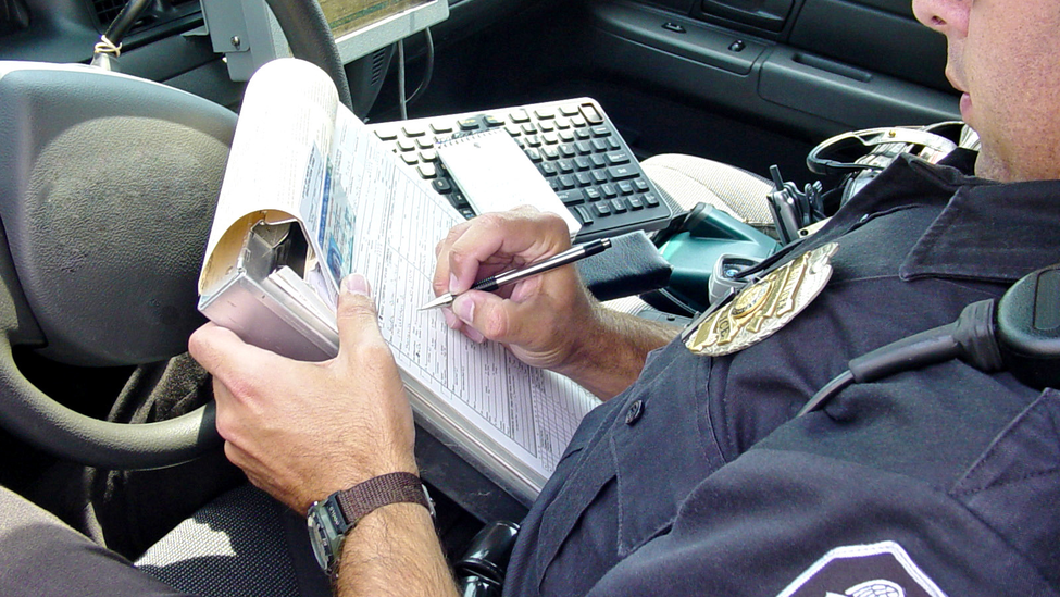 Police officer writing accident report