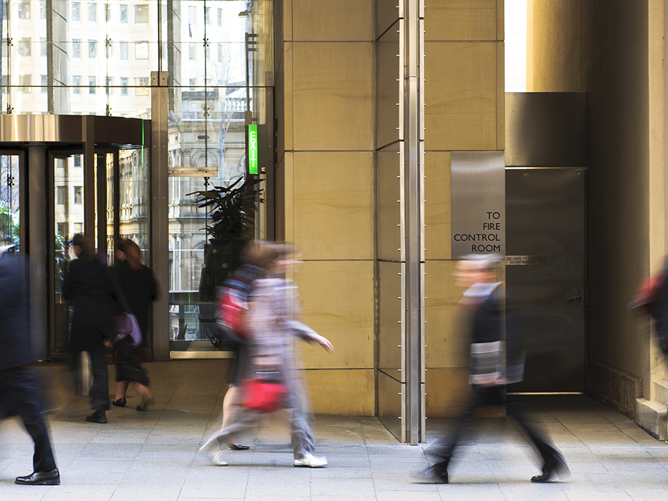 Busy sidewalk in front of a building