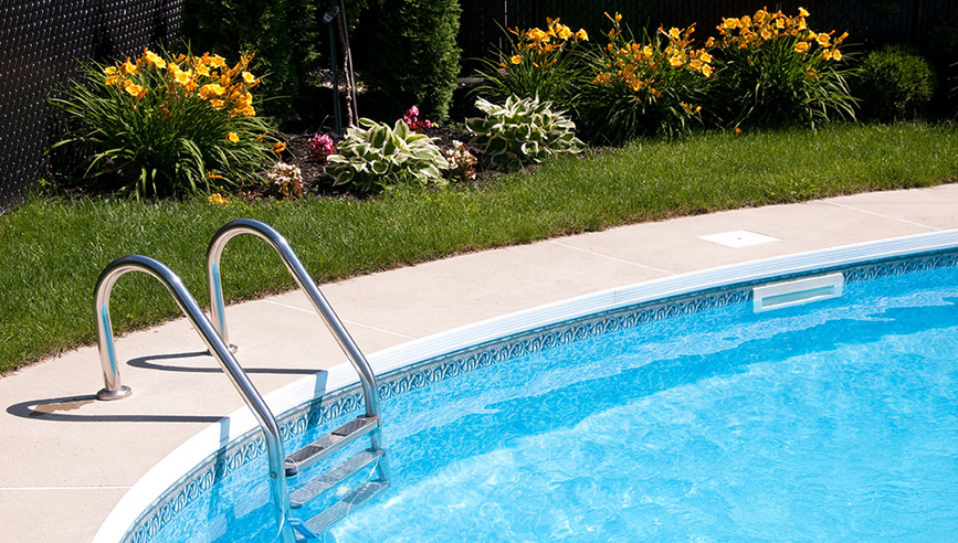 back yard pool with latter going into it.