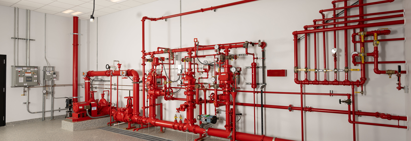 A group of red water pipes that make up the sprinkler system.