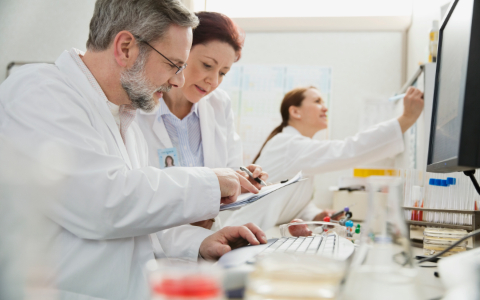 Three scientists looking at test results.