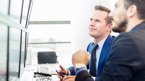 in business meeting two men looking at the screen.