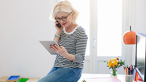 Women on call while looking at Tablet.