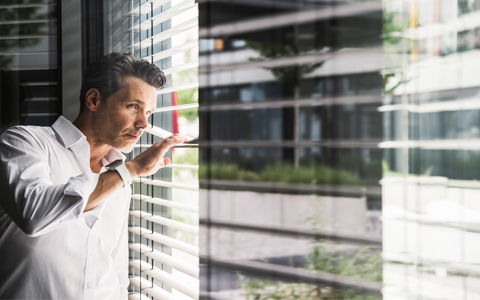 man  looking outside the window.