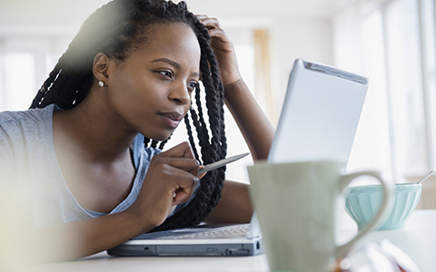 Woman pointing at a laptop screen