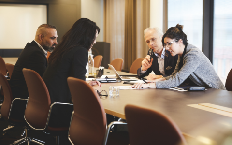 Team meeting at a conference room table.