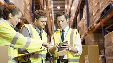 Workers discussing Workplace safety documents.