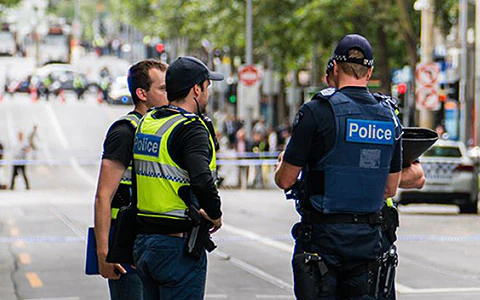 Public safety officers standing in a busy city street.