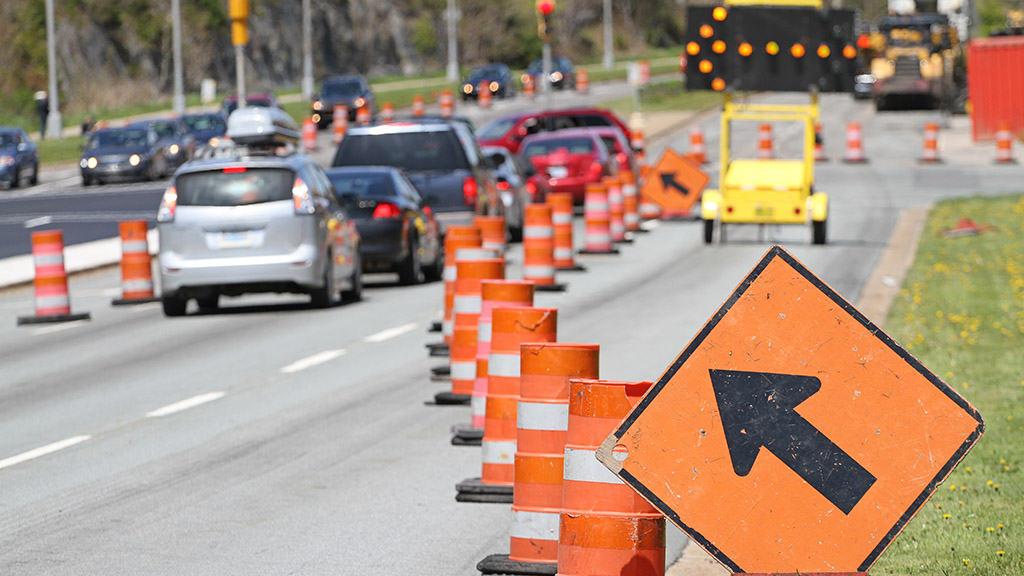 road under construction filled with traffic cones