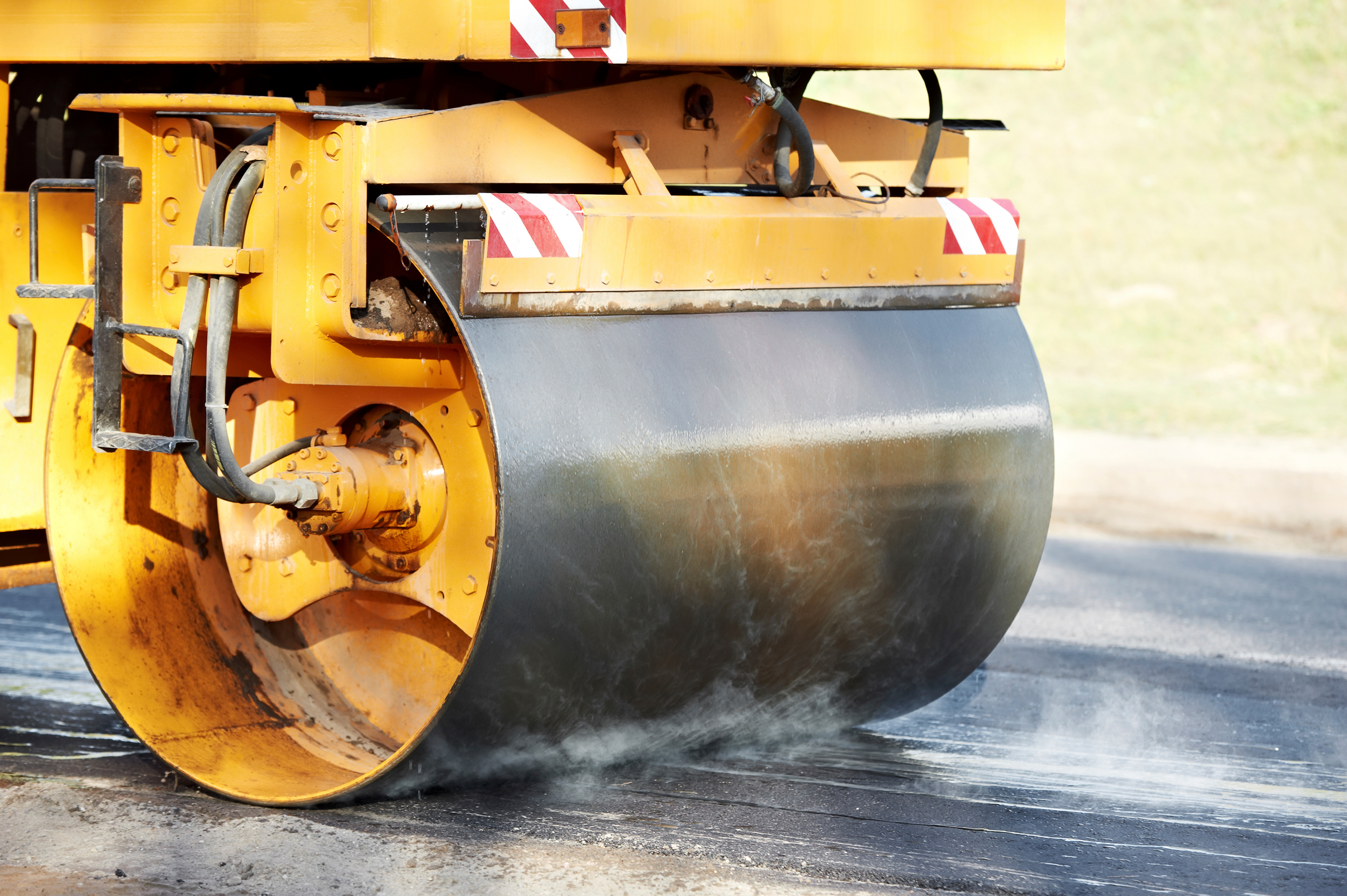 Heavy vibration roller compactor paving ashpalt road.