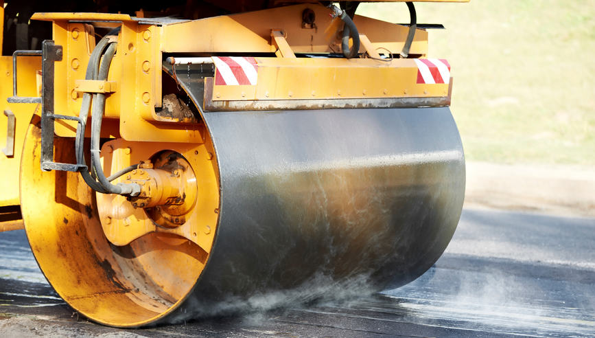 Heavy vibration roller compactor paving ashpalt road.