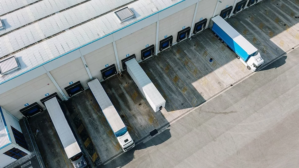 Semi-trucks parked at transportation hub.