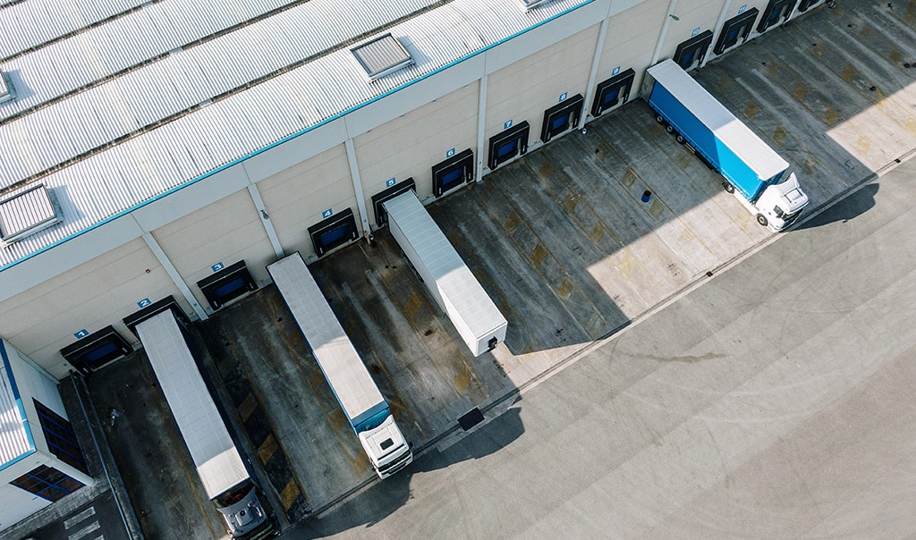 Semi-trucks parked at transportation hub.