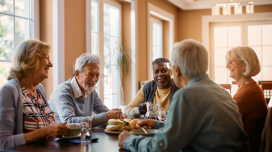 A group of senior citizens eating lunch together.